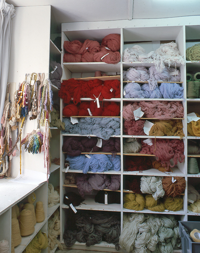 Détail des casiers du magasin des laines, avec les moches rangées par nuances de couleurs.