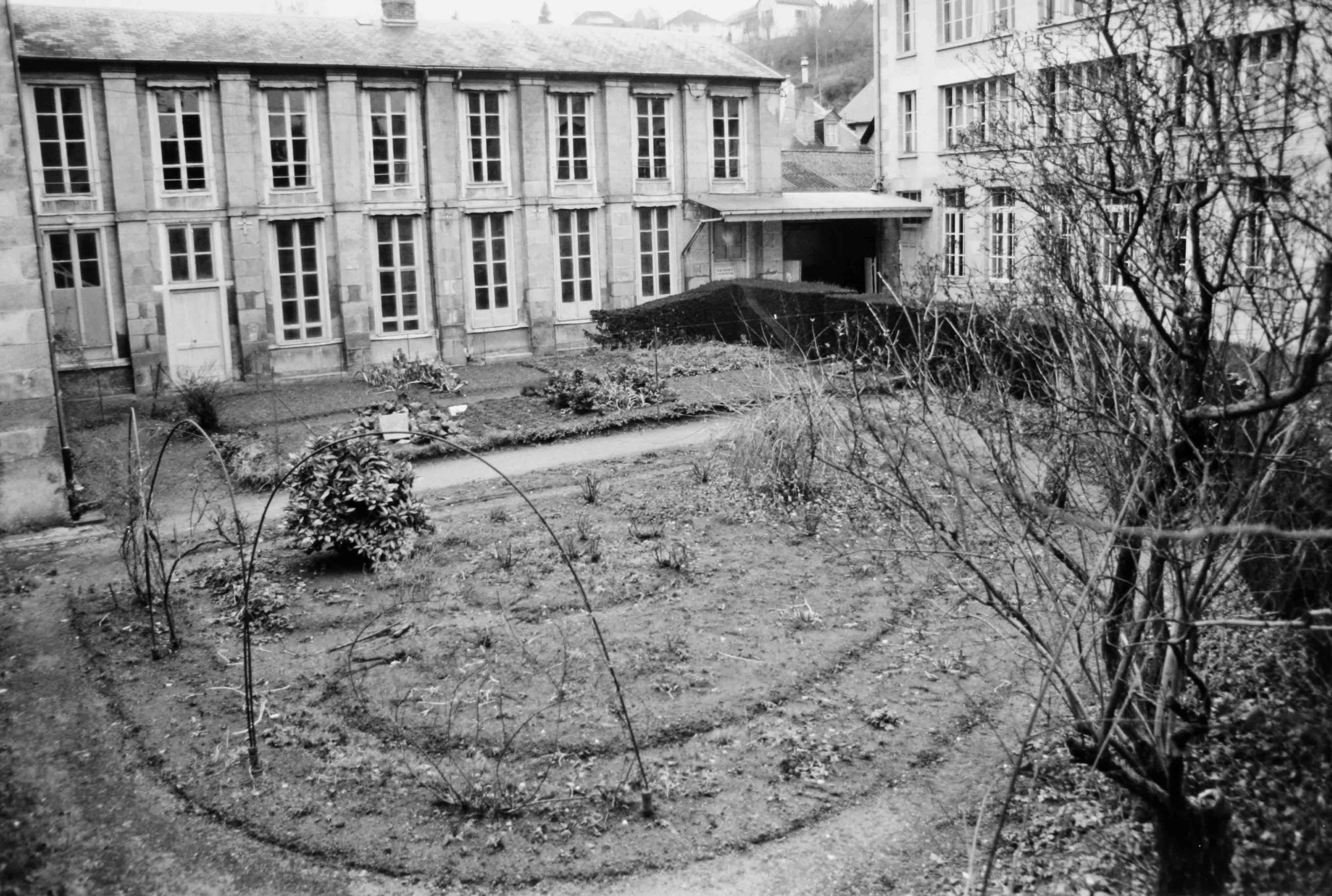 A l'ouest de la cour : les deux niveaux de la galerie d'exposition (aujourd'hui disparue) et les jardins de la manufacture (reportage photographique de L. Yeghicheyan, 1992, Aubusson, Musée départemental de la Tapisserie)