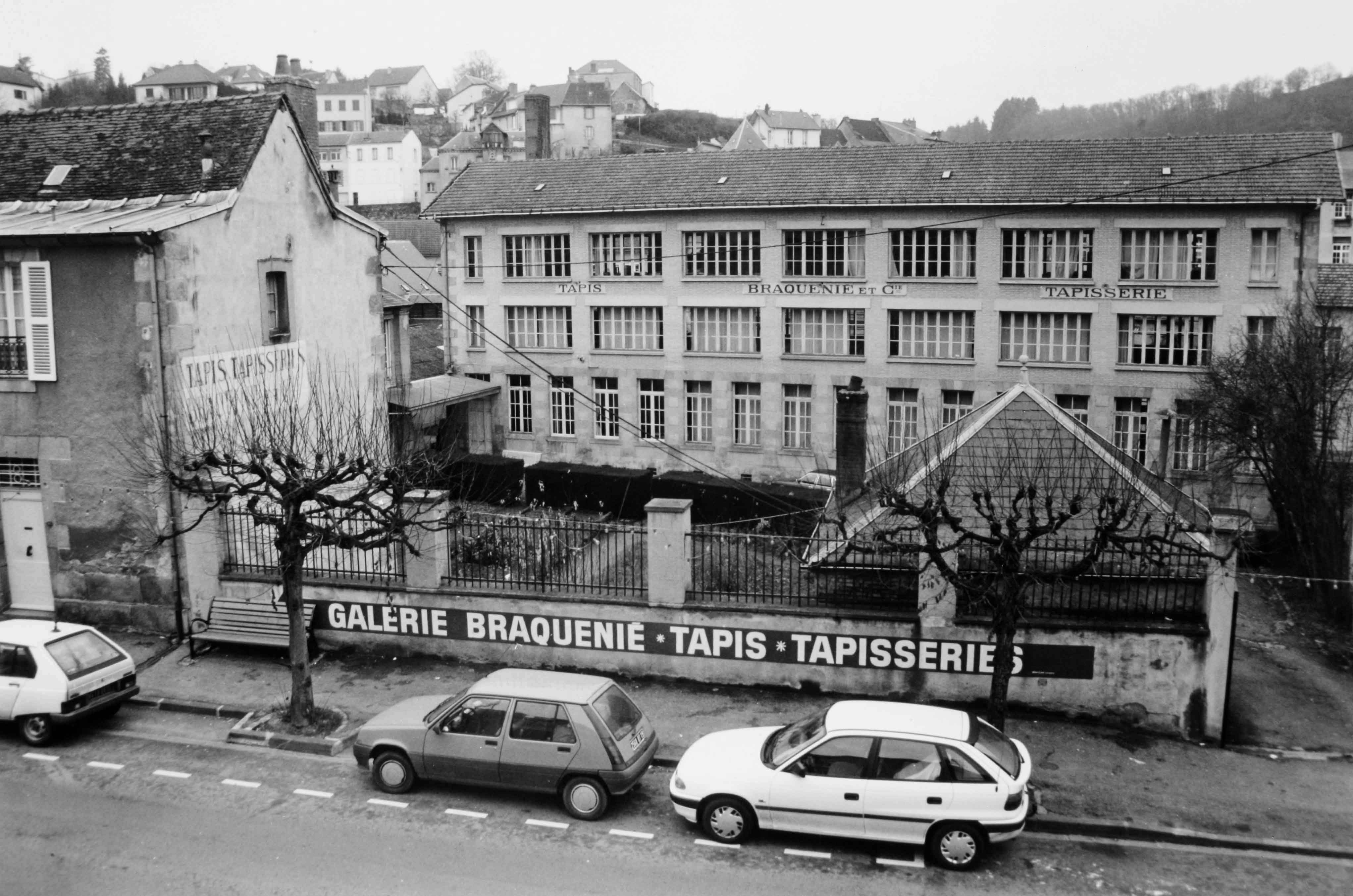 L'entrée de la manufacture, sur l'avenue de la République et l'élévation sud du bâtiment des ateliers de tissage (reportage photographique de L. Yeghicheyan, 1992, Aubusson, Musée départemental de la Tapisserie)