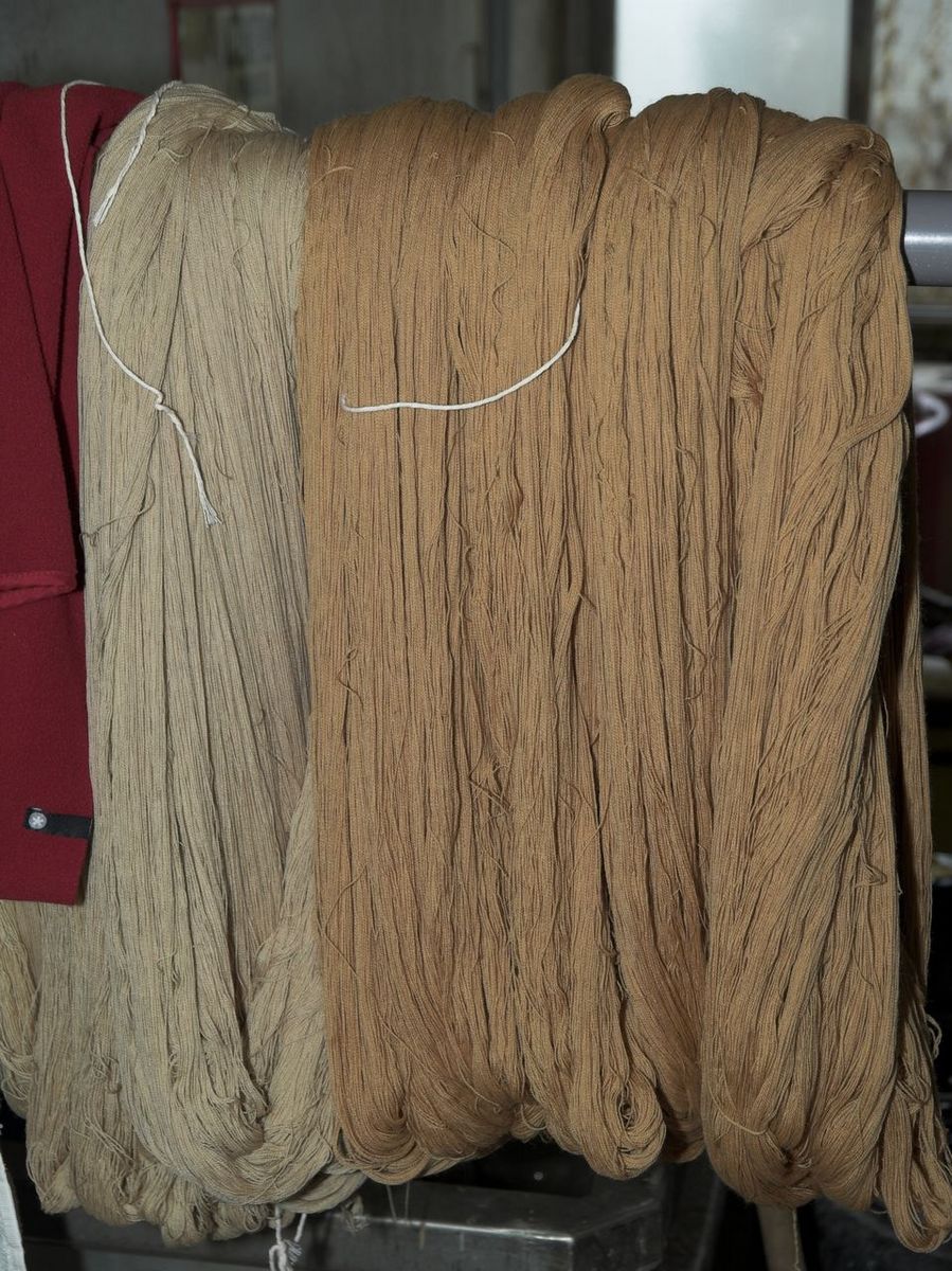 Détail des écheveaux de laine colorés, sur un lissoir.