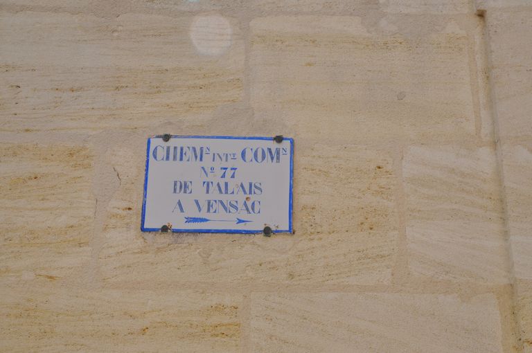 Plaque d'indication routière fixée sur la façade d'une maison : Chemin intercommunal n°77 de Talais à Vensac.