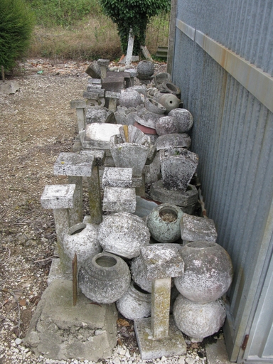 Eléments de mobilier de jardin rassemblés près de l'atelier.