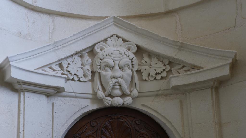 Appartements du roi, au premier étage : détail de mascaron décorant le fronton d'une porte.