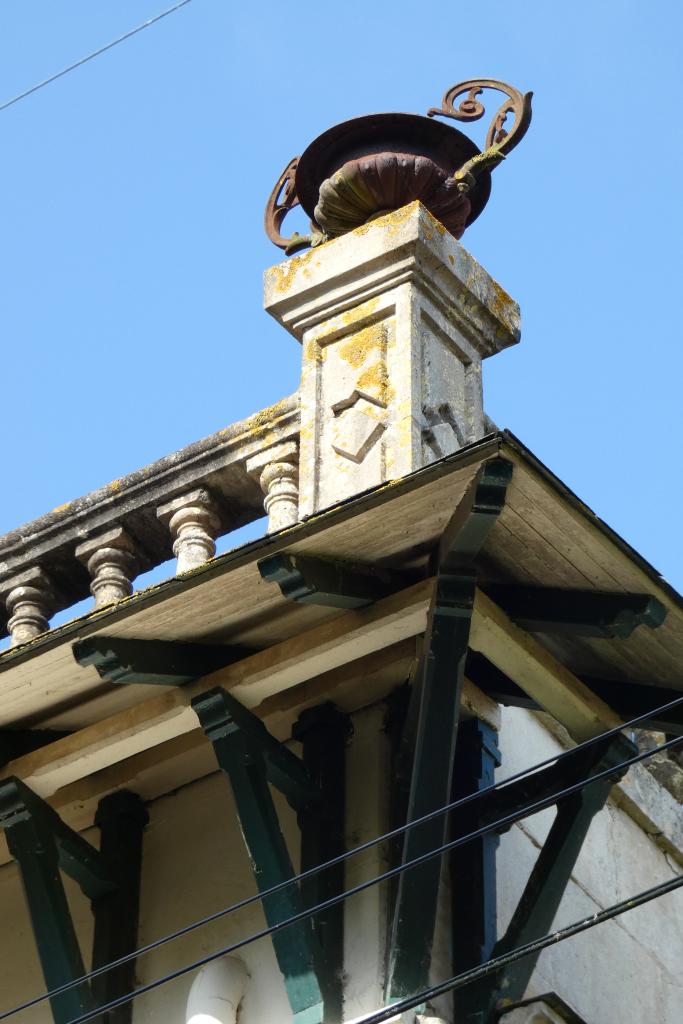 Vase d'amortissement en métal et détail de l'avant-toit.