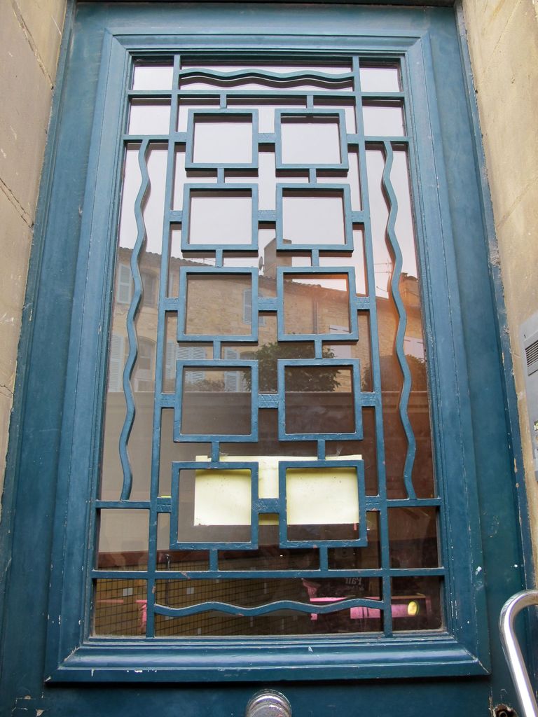 Détail de la porte de la première travée de la façade sur la rue de Paris : ferronnerie des années 1930.